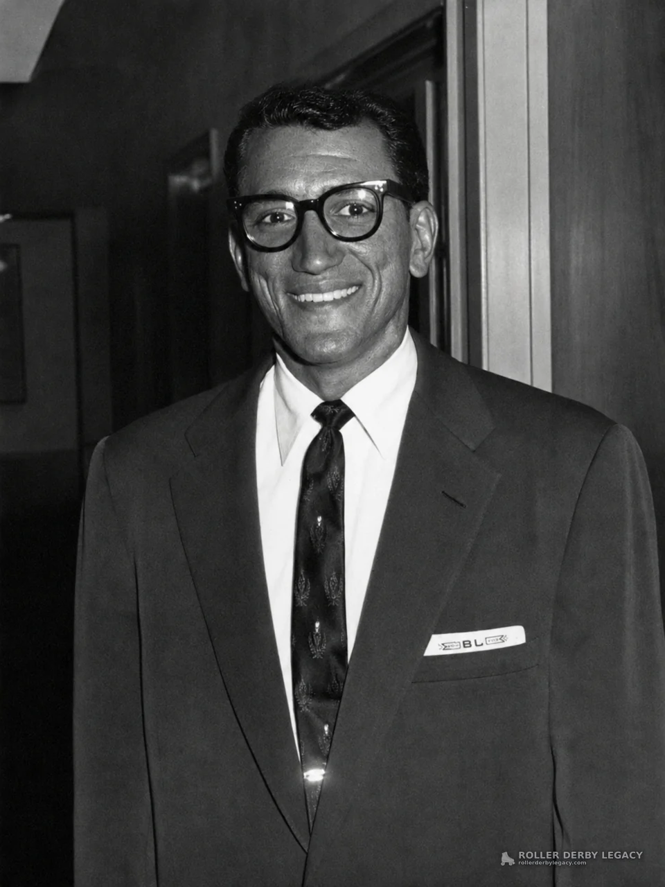 Smiling Man in Suit and Glasses