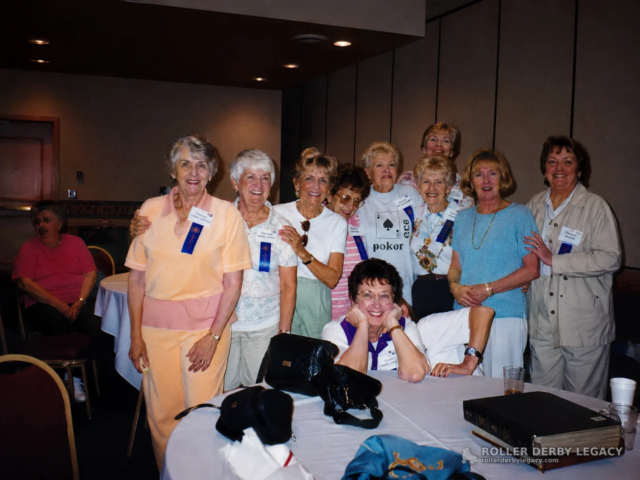 Women Wearing Name Tags and Blue Ribbons in a Banquet Room