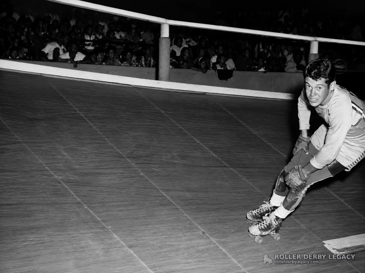 Roller Derby Skater Leaning Into a Turn on an Indoor Track