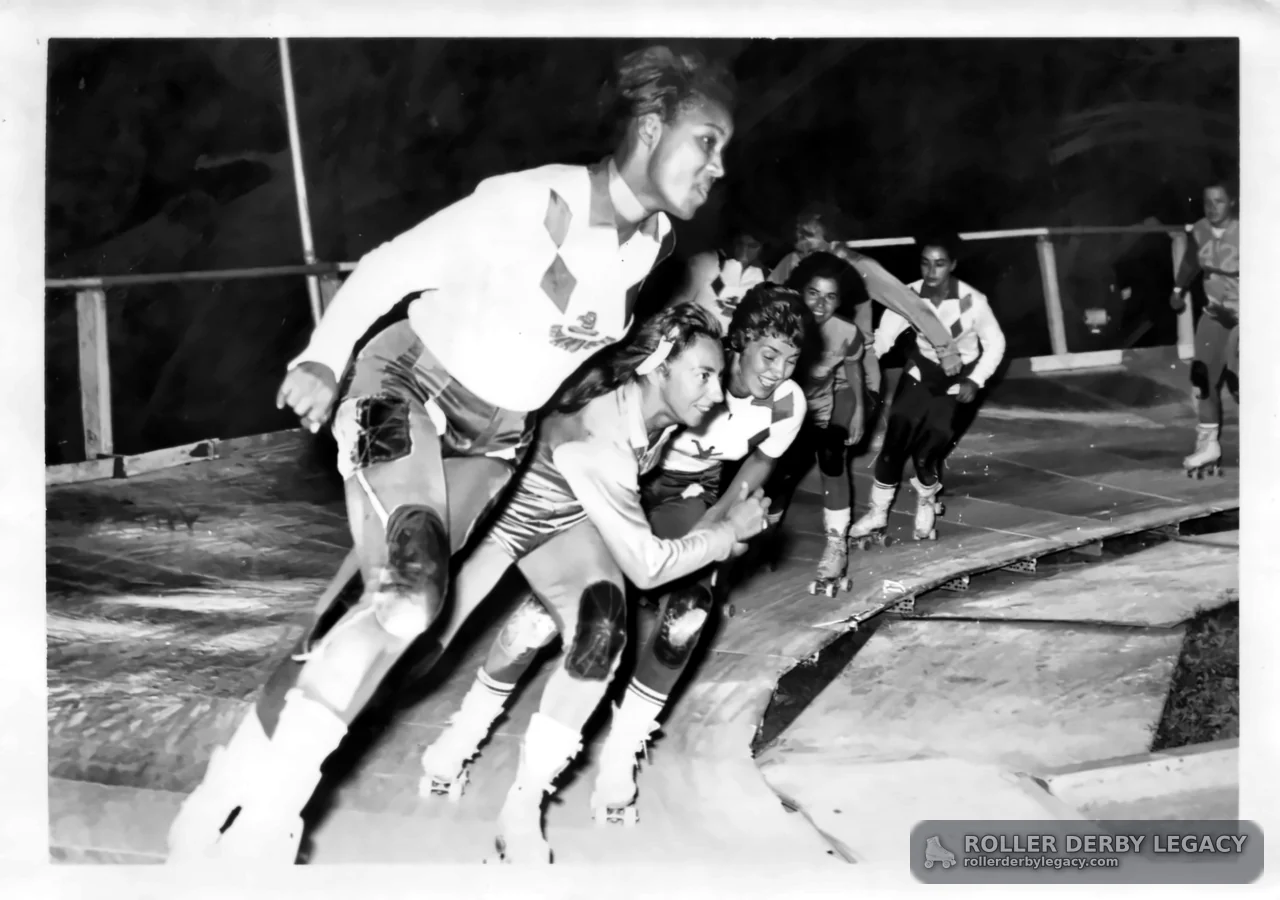 Roller Derby Skaters Racing Through a Turn