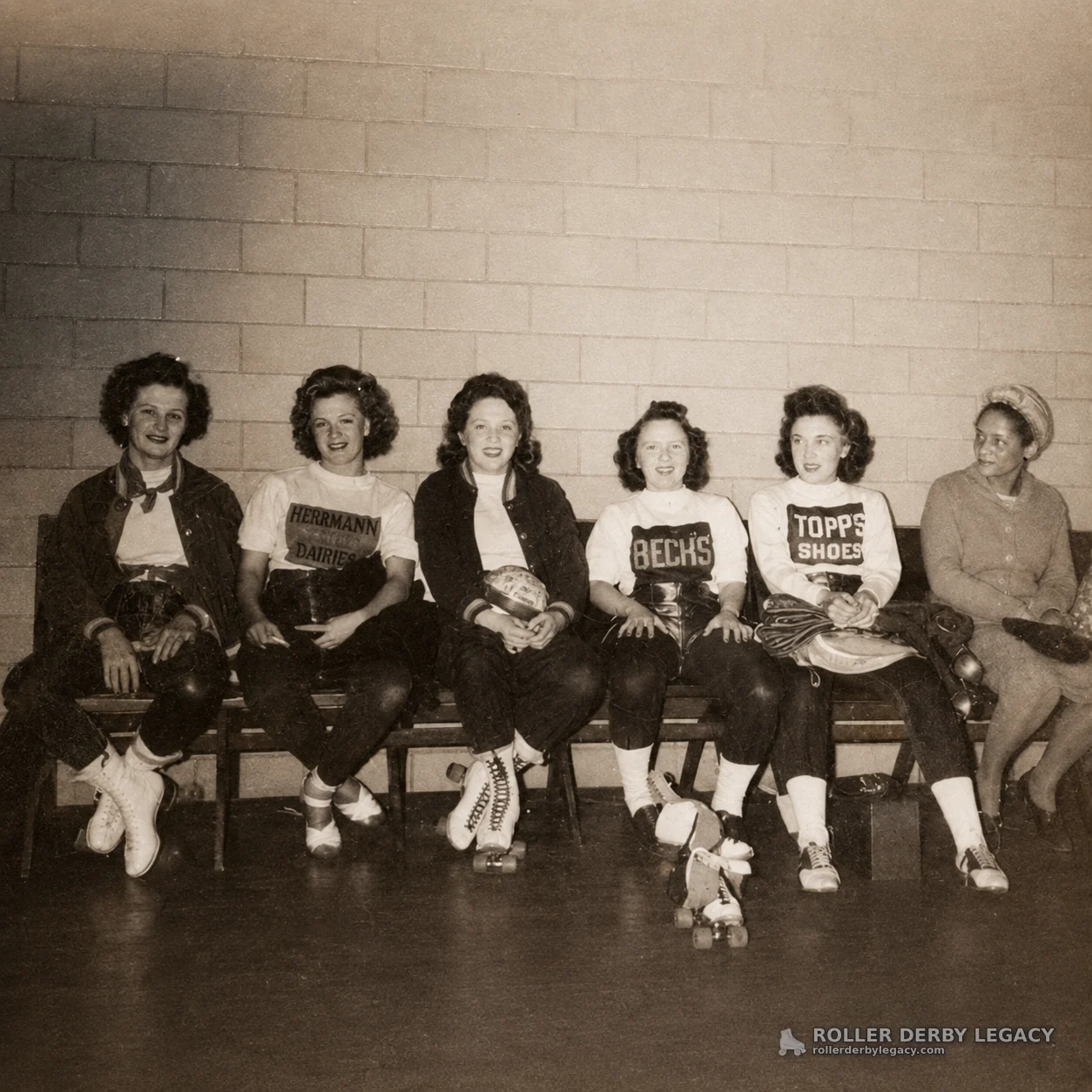 Six Women with Roller Skates and Sponsor Shirts