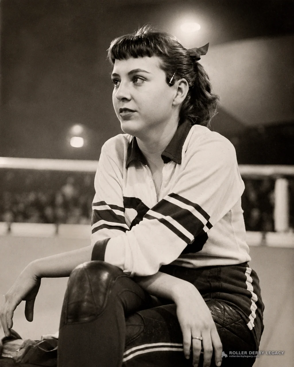 Seated Roller Derby Athlete in Arena Portrait