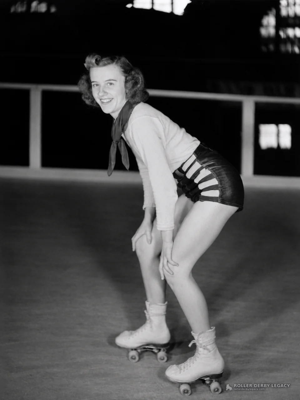 Smiling Skater Posing in an Indoor Rink