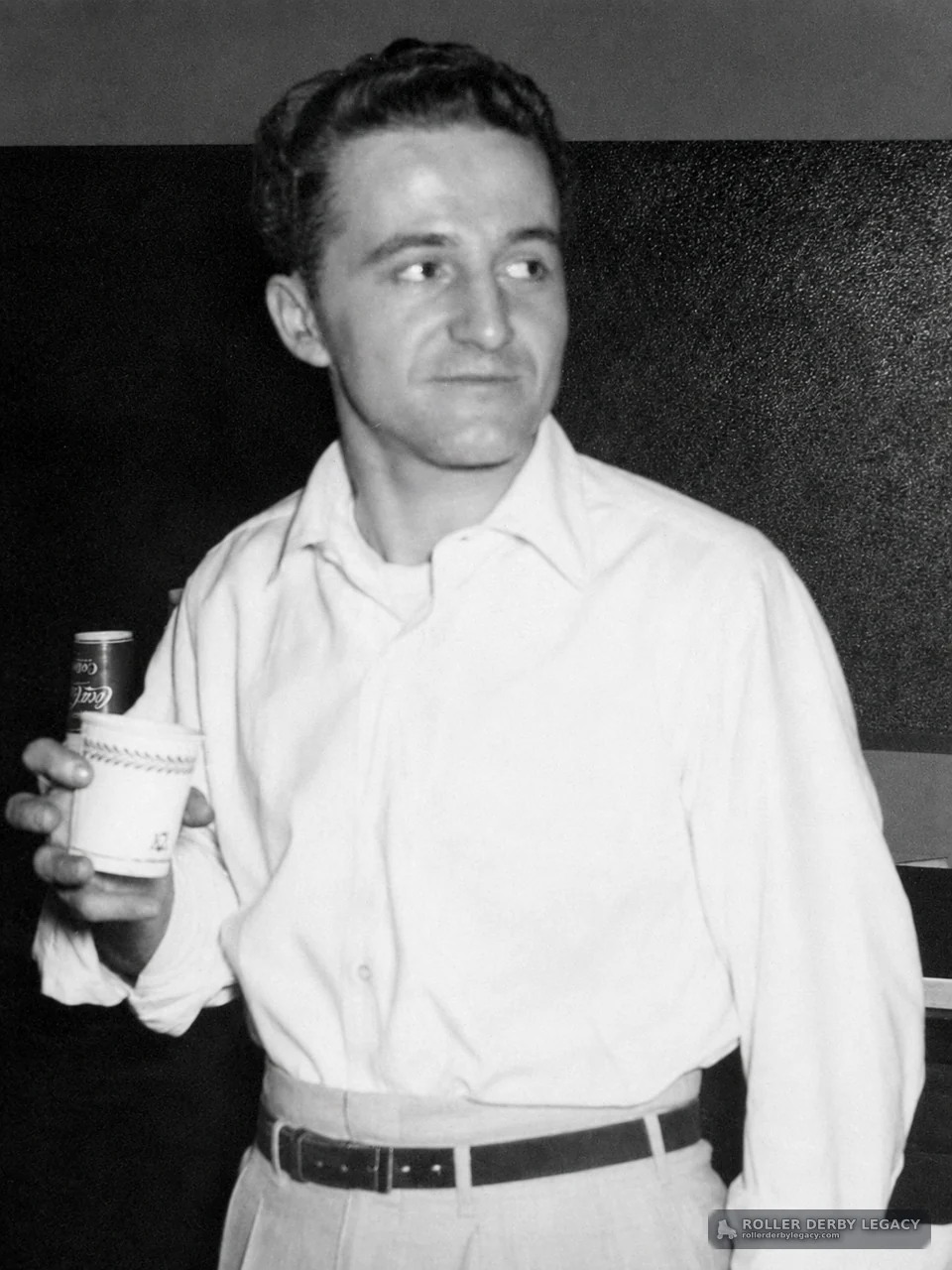 Unidentified Man Holding a Paper Cup and Soda Can