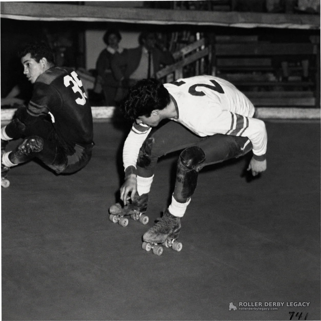 Two Roller Derby Skaters in Low Indoor Action
