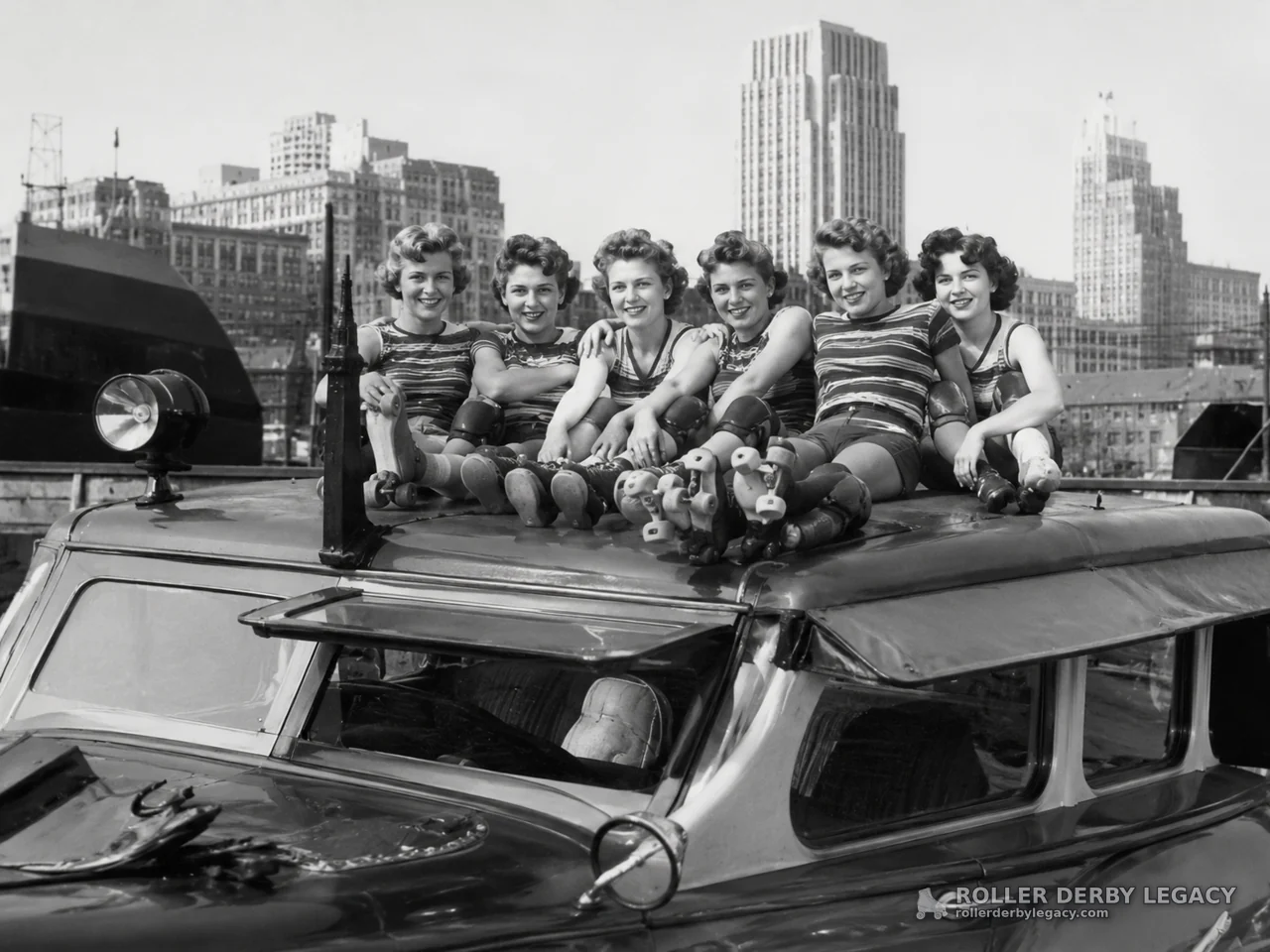 Women Roller Skaters Posing on a Vehicle Roof