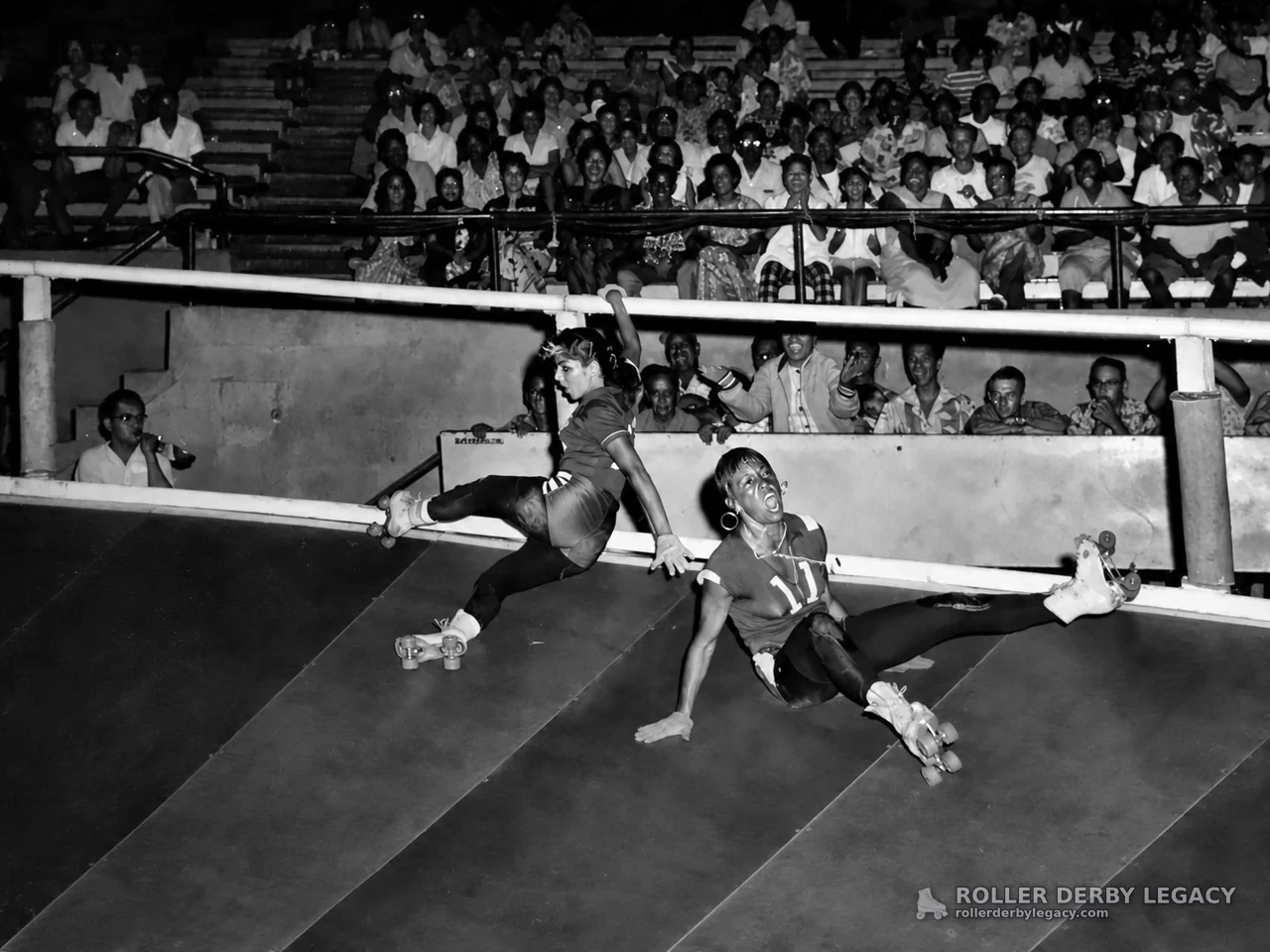 Roller Derby Skaters Slide on a Banked Track