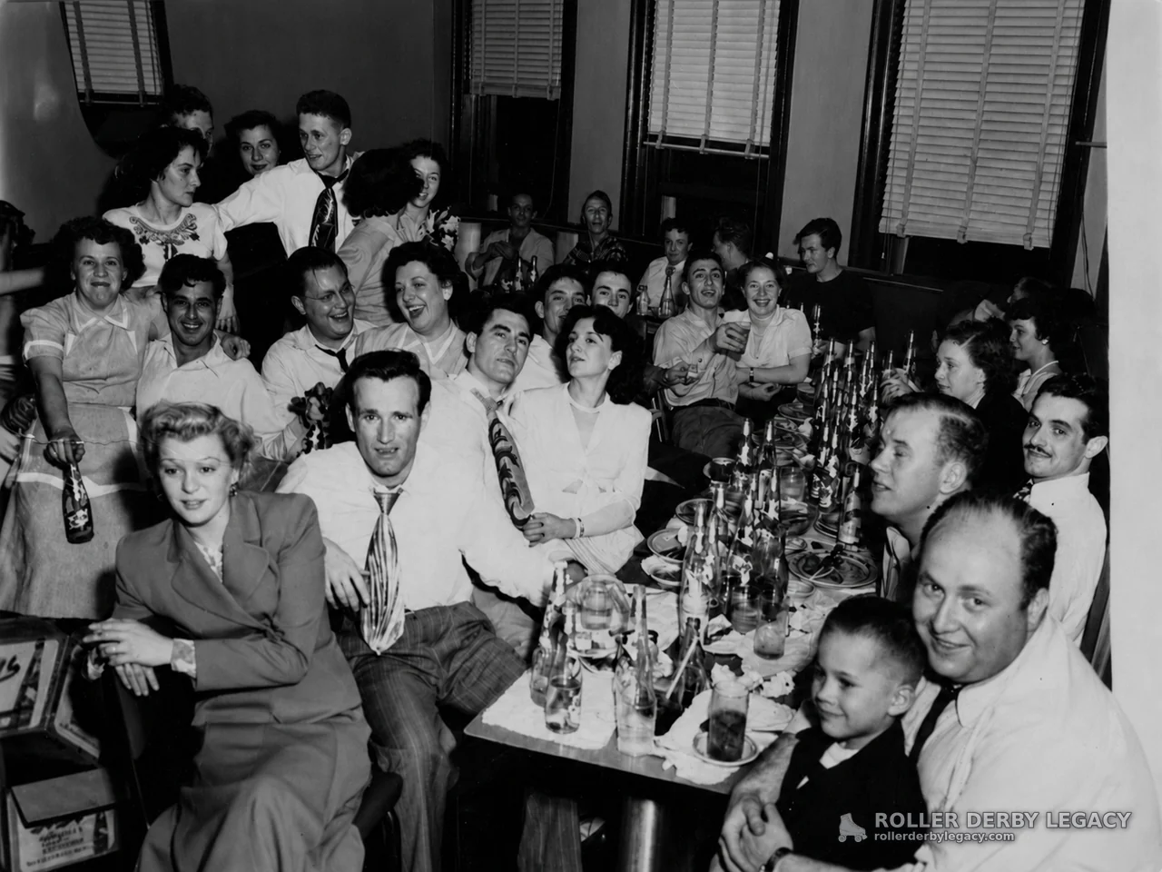 Indoor Party Group Around a Crowded Dining Table