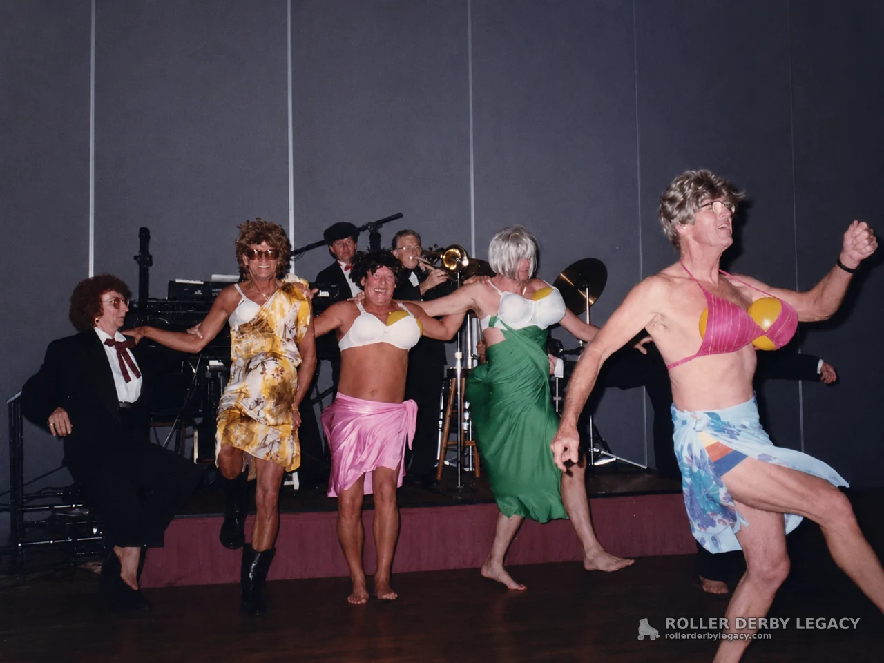 Costumed Dancers Performing in Front of a Band
