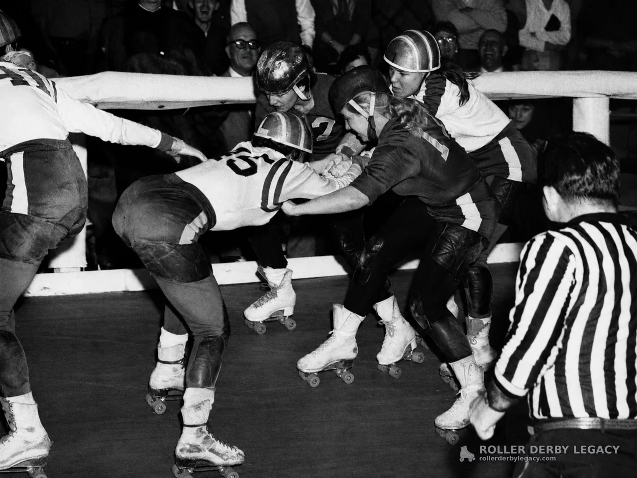 Roller Derby Skaters Clash at the Rink Rail