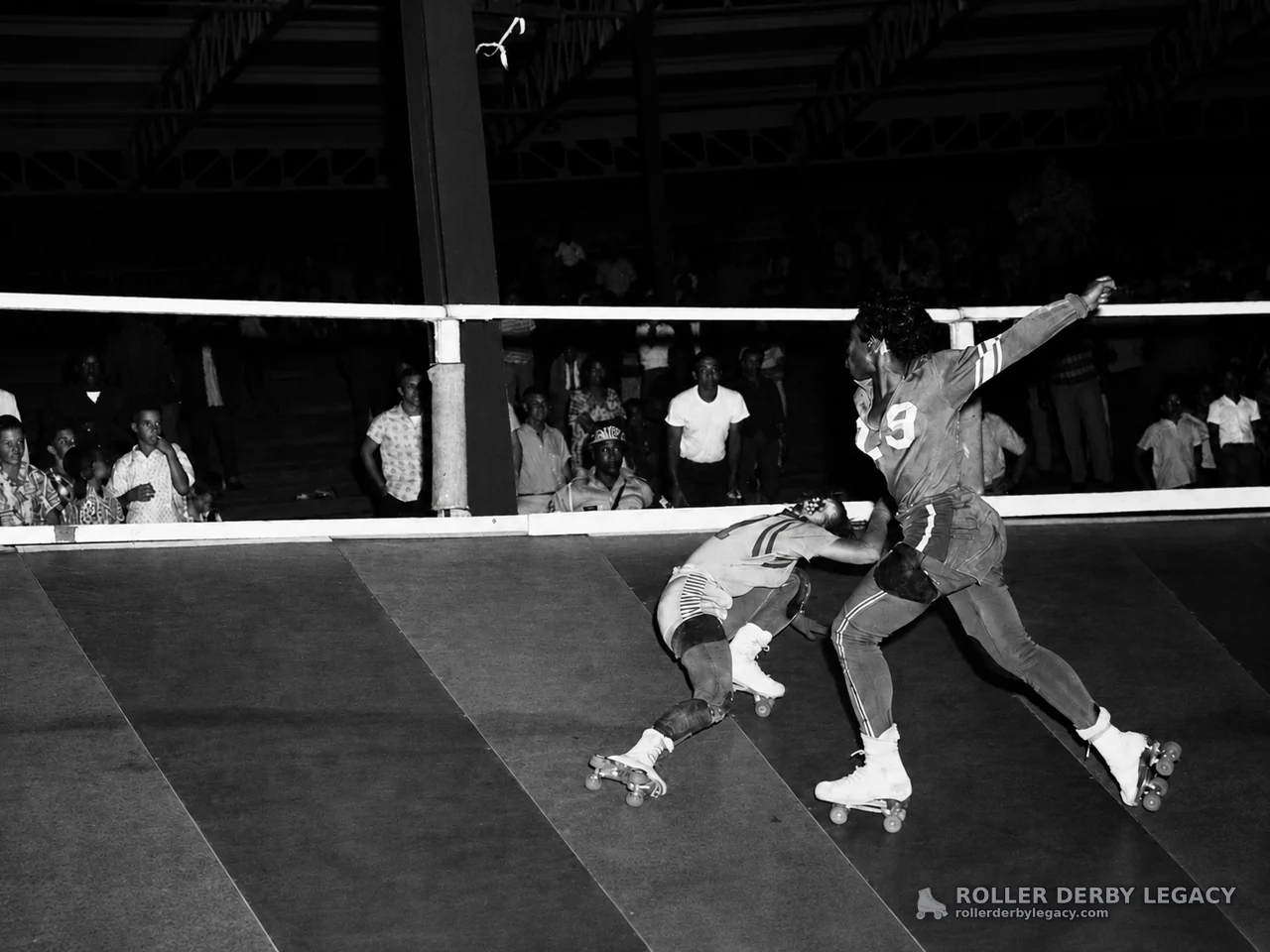 Roller Derby Skaters Compete Near the Track Rail
