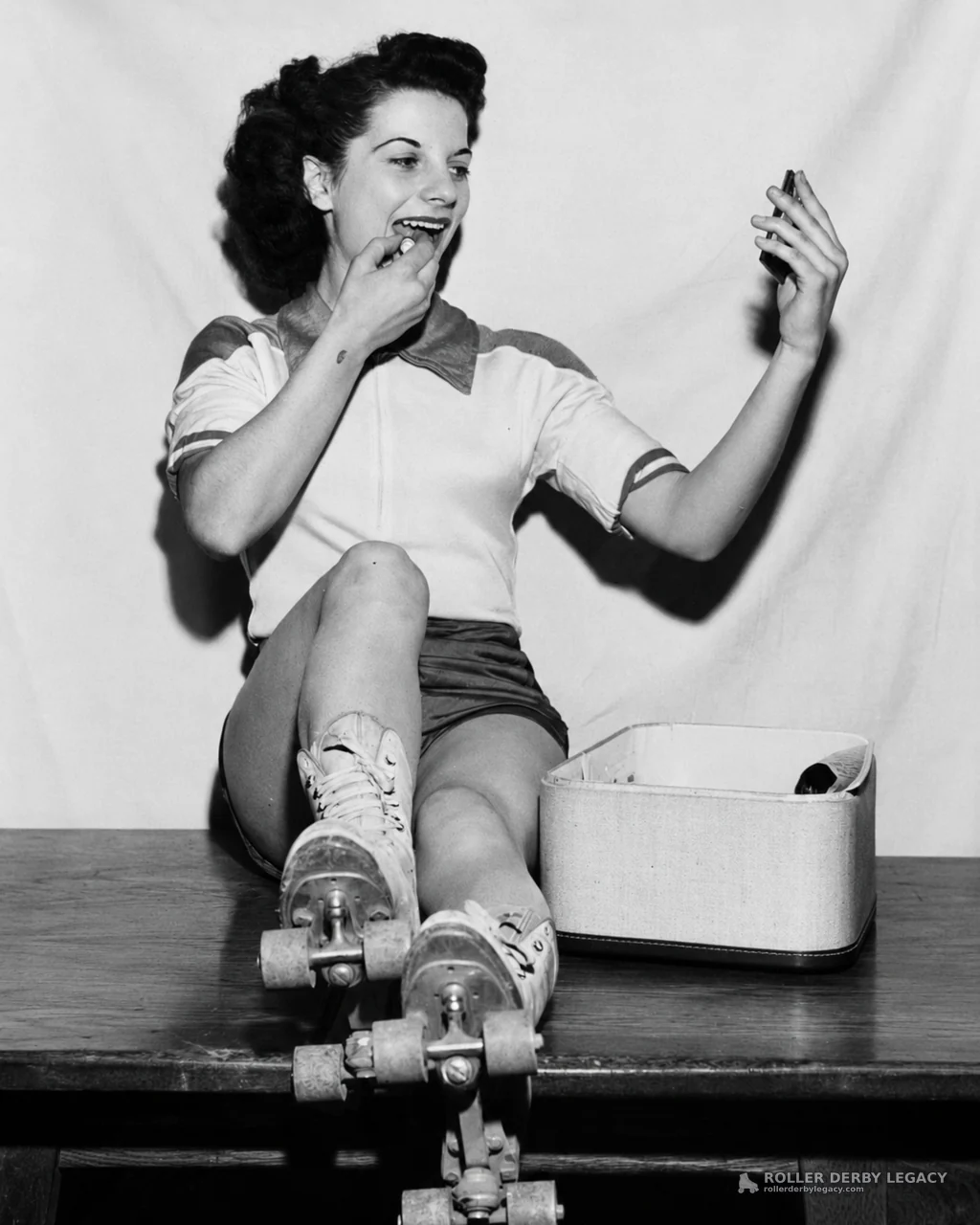 Roller skater applying lipstick in studio portrait