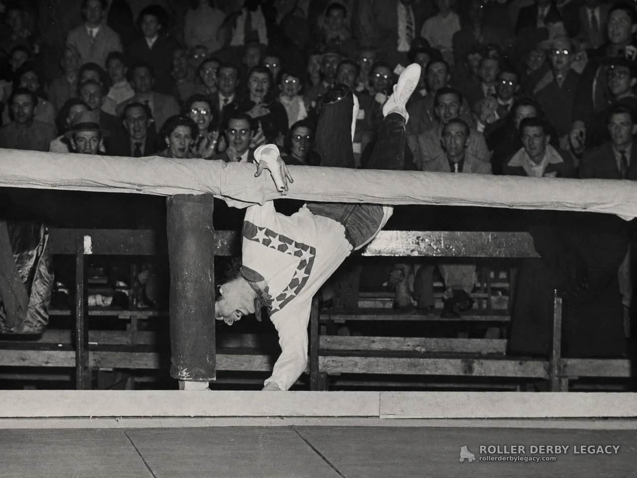 Skater Upside Down Over Padded Arena Rail