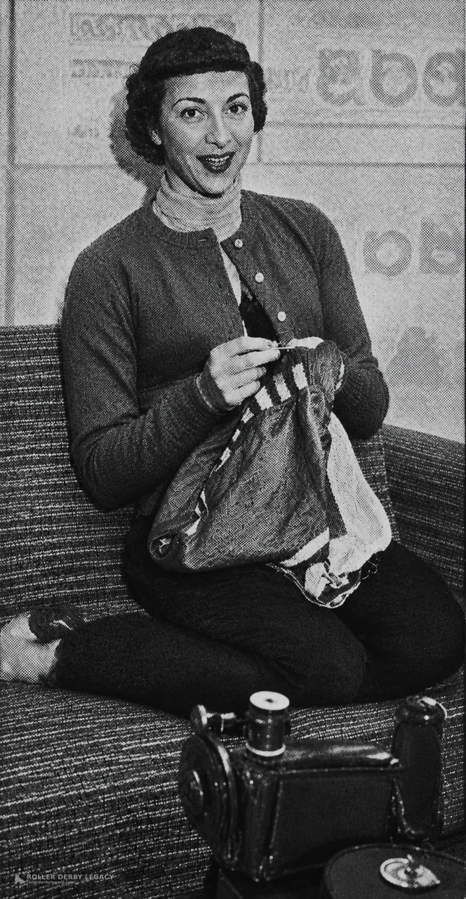 Woman Mending Fabric Beside a Sewing Machine