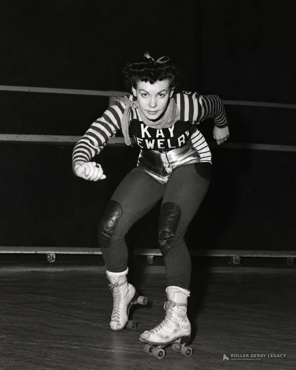 Roller Skater in Striped Uniform at an Indoor Rink