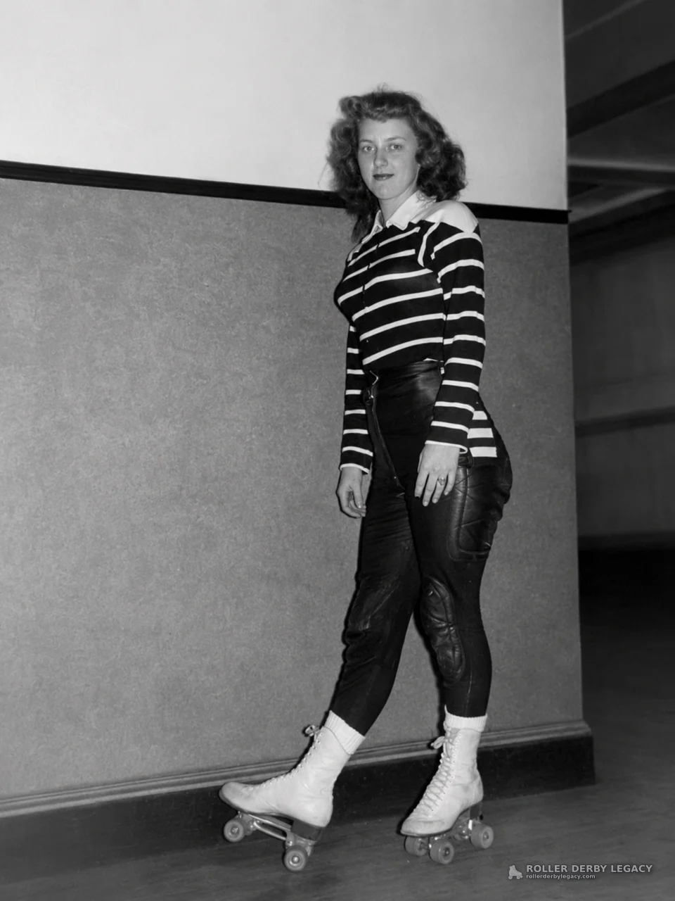 Unidentified Skater in Striped Top at an Indoor Rink