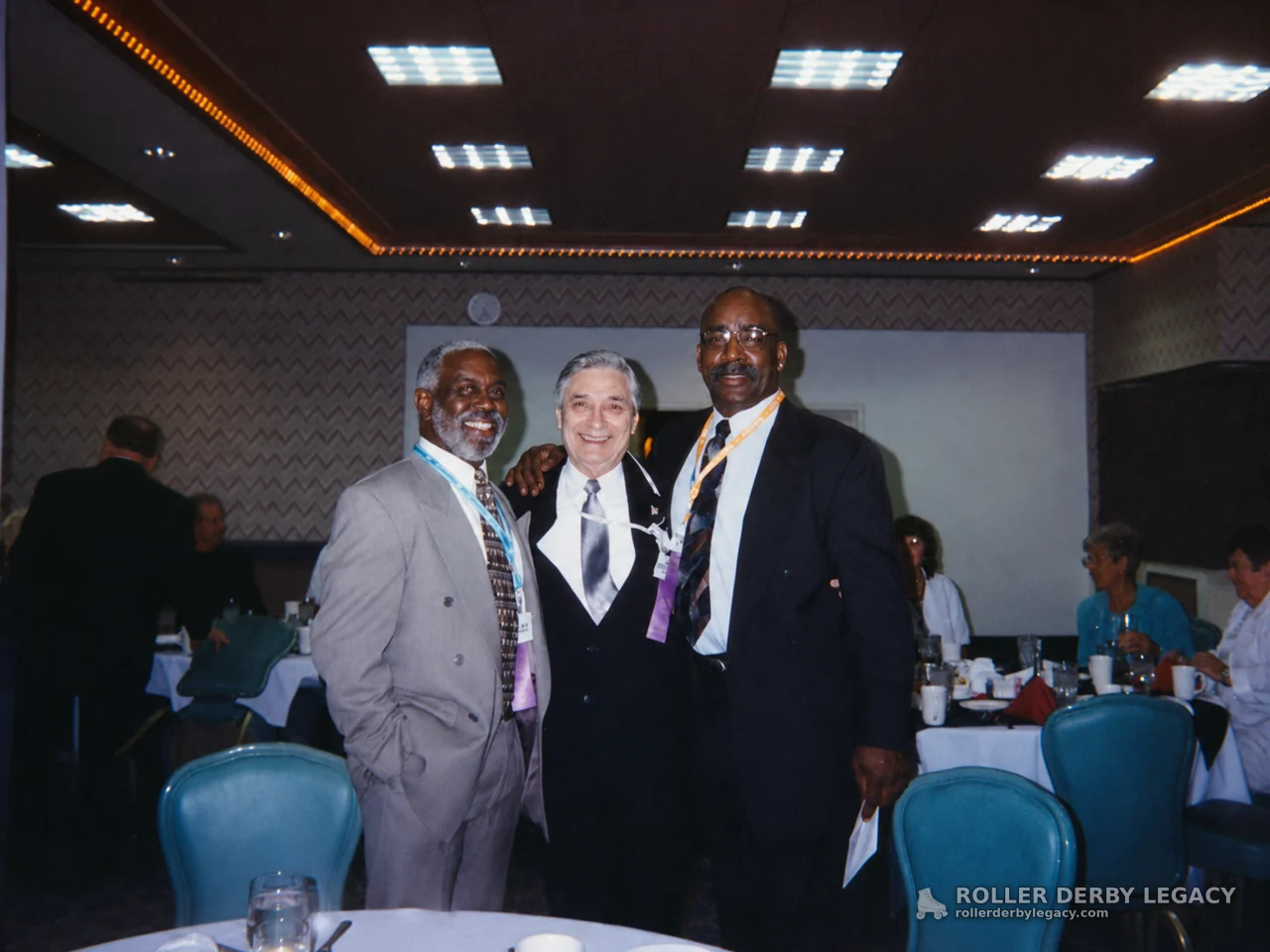 Three Men in Suits at a Banquet