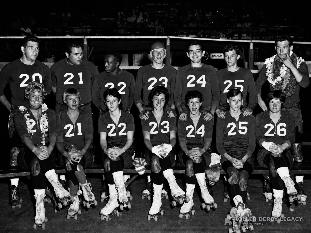 Numbered Roller Skaters Posed in an Indoor Arena