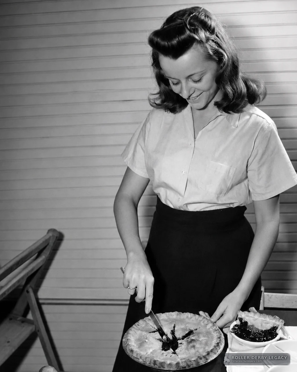 Woman Cutting a Pie Indoors