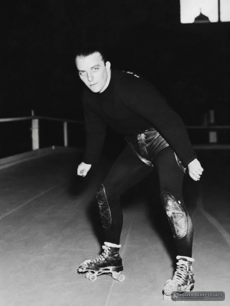 Crouching Roller Skater in an Indoor Rink