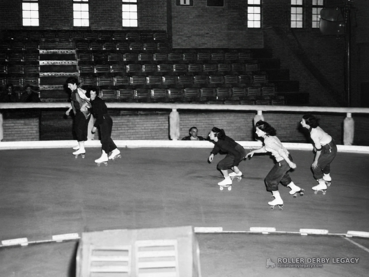 Roller Skaters on an Indoor Track
