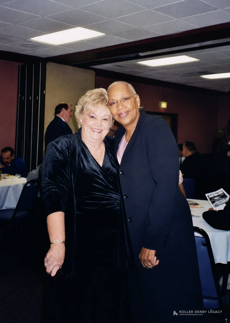 Two Women Smiling at a Banquet Gathering