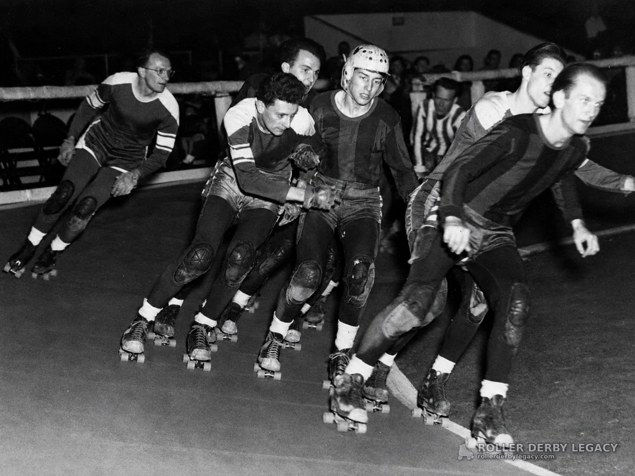 Roller Skaters Racing in a Tight Indoor Pack