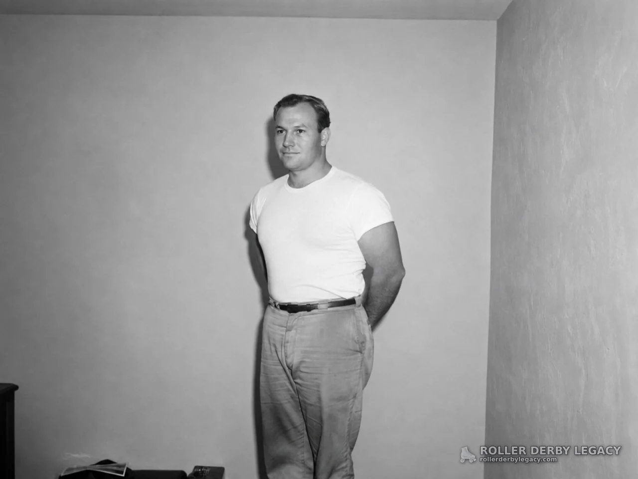 Unidentified Man Standing in Plain Room