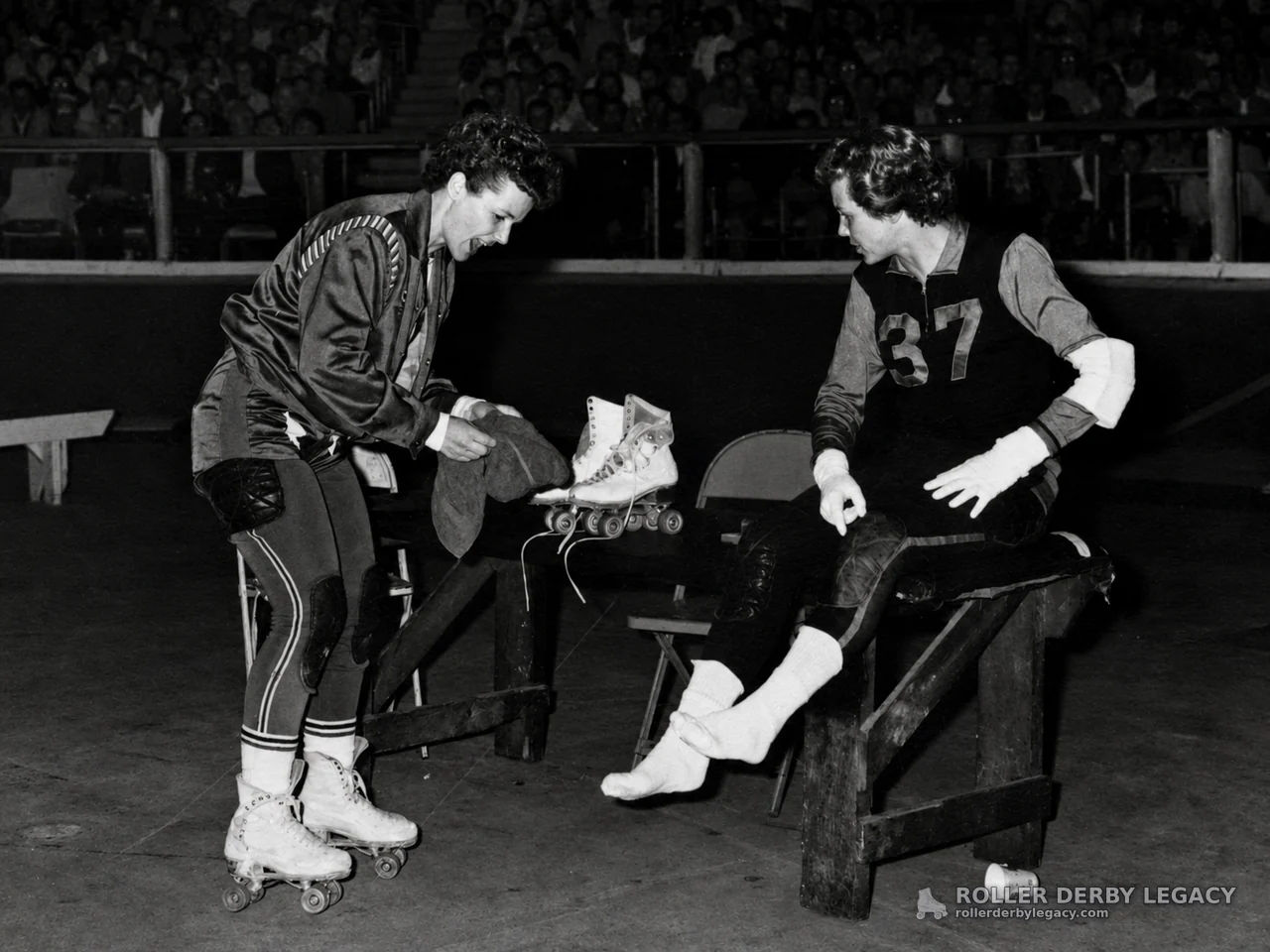 Roller Skaters Beside Benches in an Indoor Arena