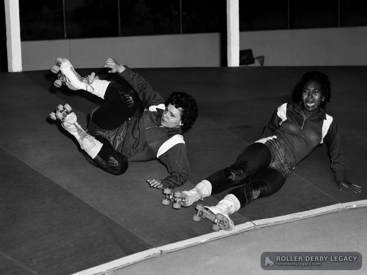 Skaters Fallen on an Indoor Rink