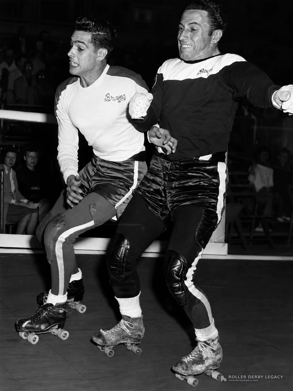 Two Roller Derby Skaters in Action, One Wearing a Braves Shirt