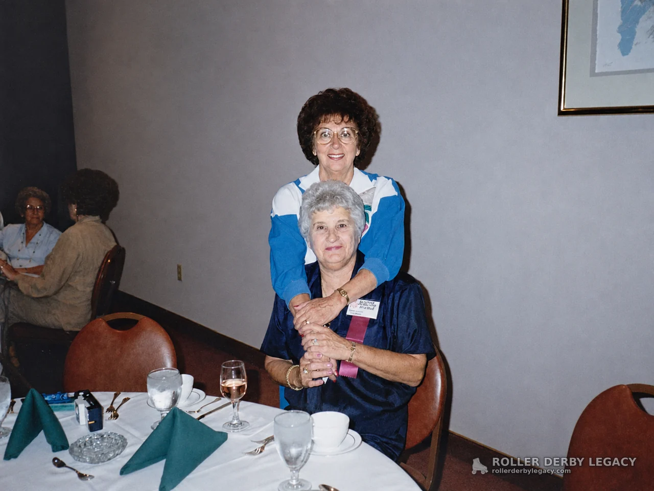 Two Women Posing at a Banquet Table