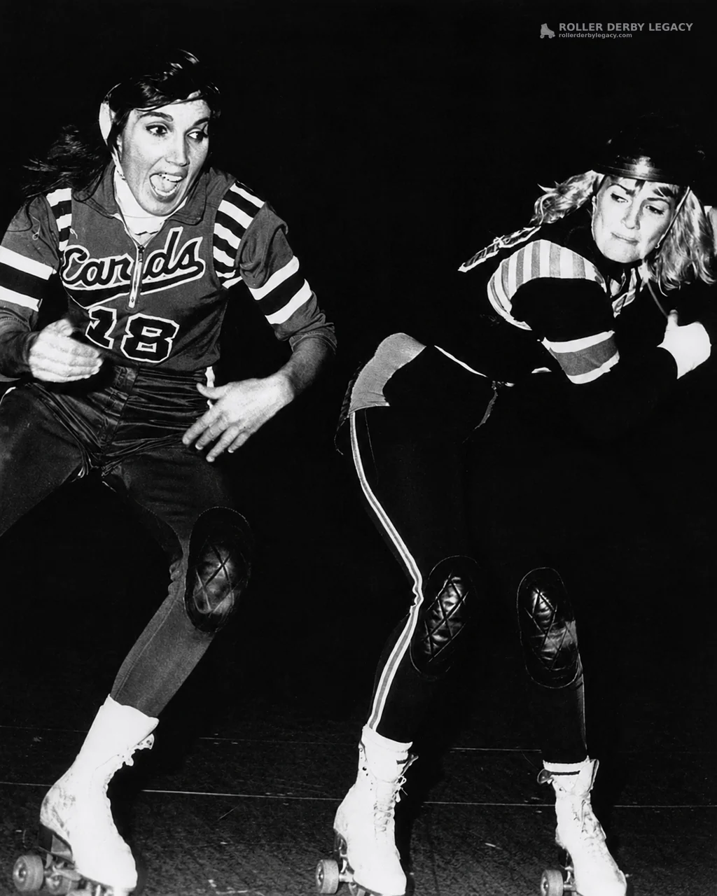 Two Roller Skaters in Action, One Wearing “Cards” Number 28