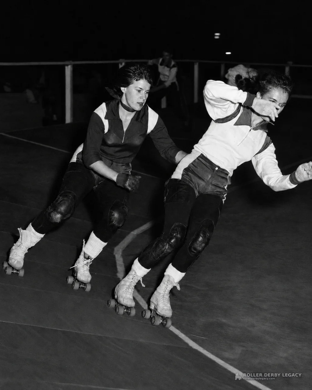 Two Skaters Lean Through a Roller Derby Turn