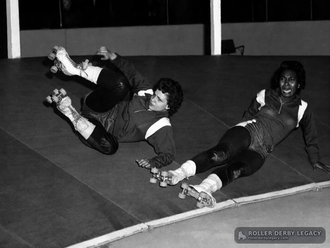 Two Skaters Down on a Banked Track