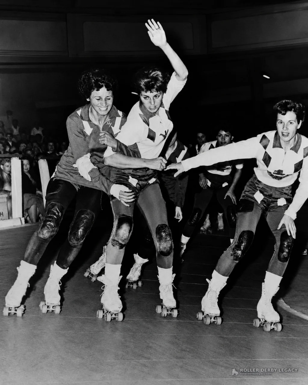 Roller Derby Skaters Jostle on an Indoor Track