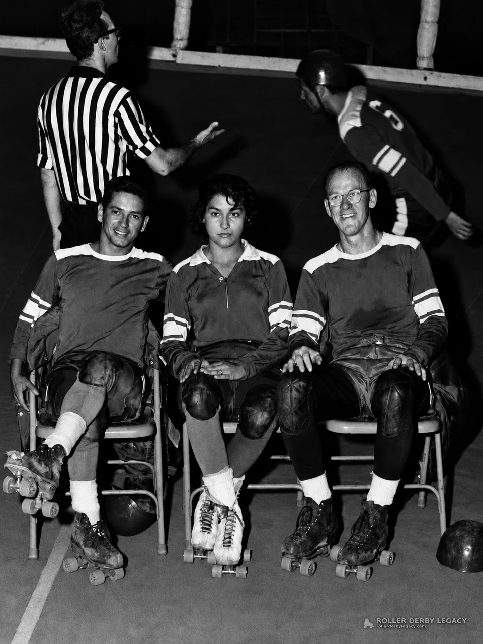 Seated Roller Derby Skaters on an Indoor Track