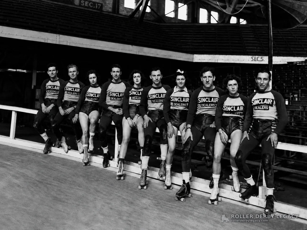 Sinclair Dealers Skaters Posed at an Indoor Rink Rail