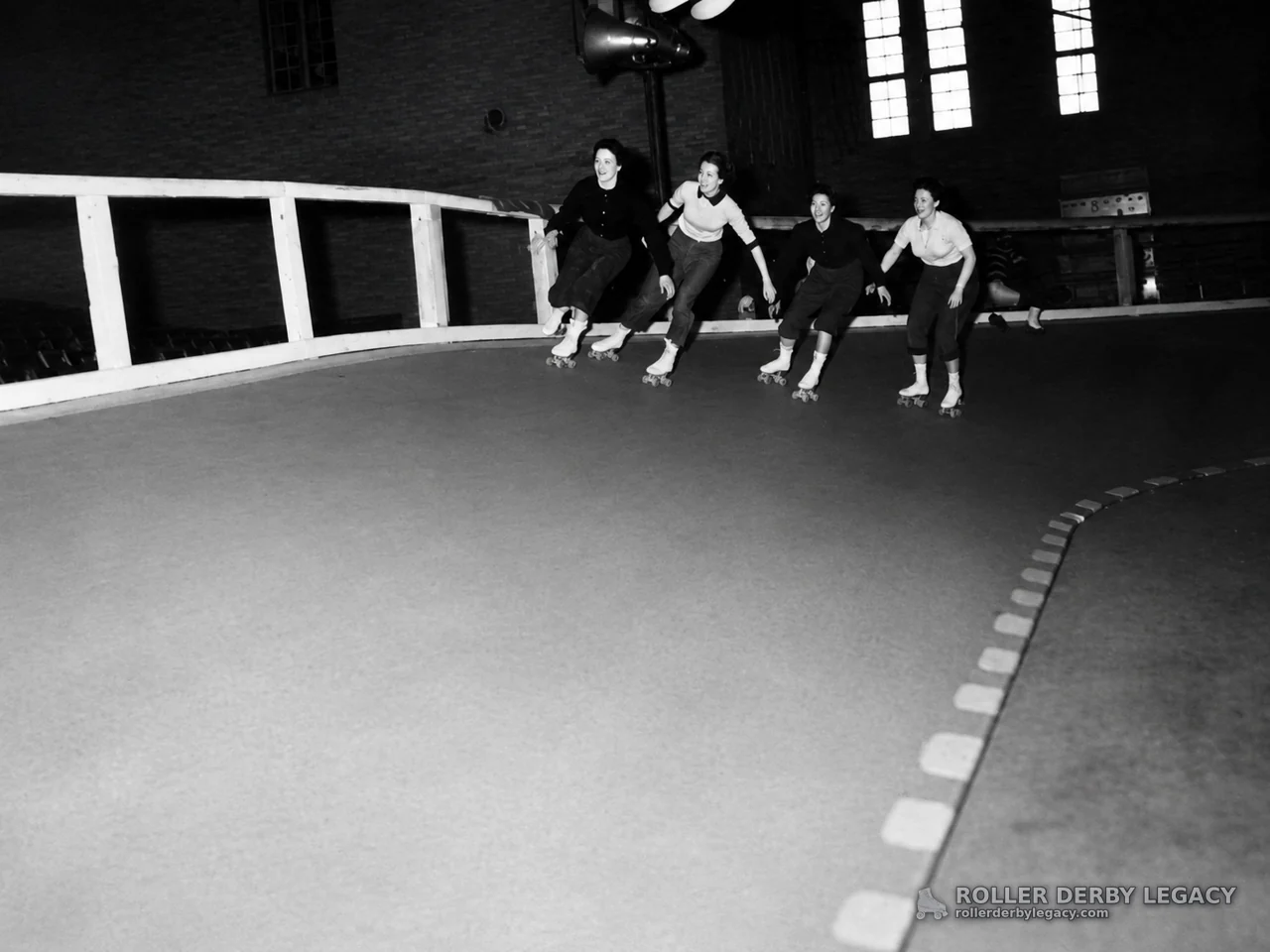 Skaters Rounding an Indoor Track Curve