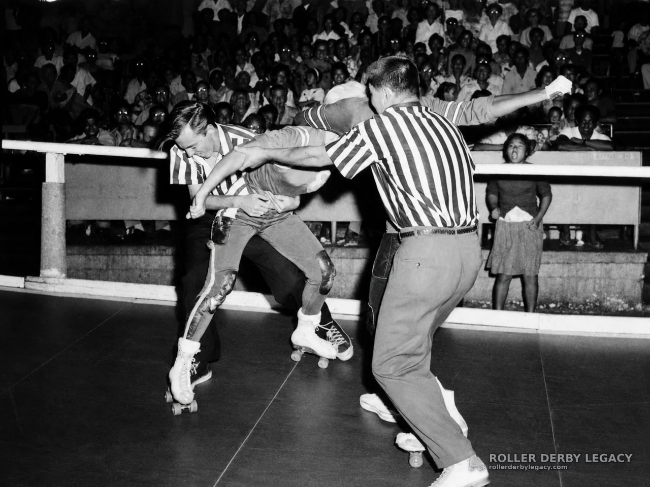 Roller Derby Action with Officials at Crowded Indoor Rink