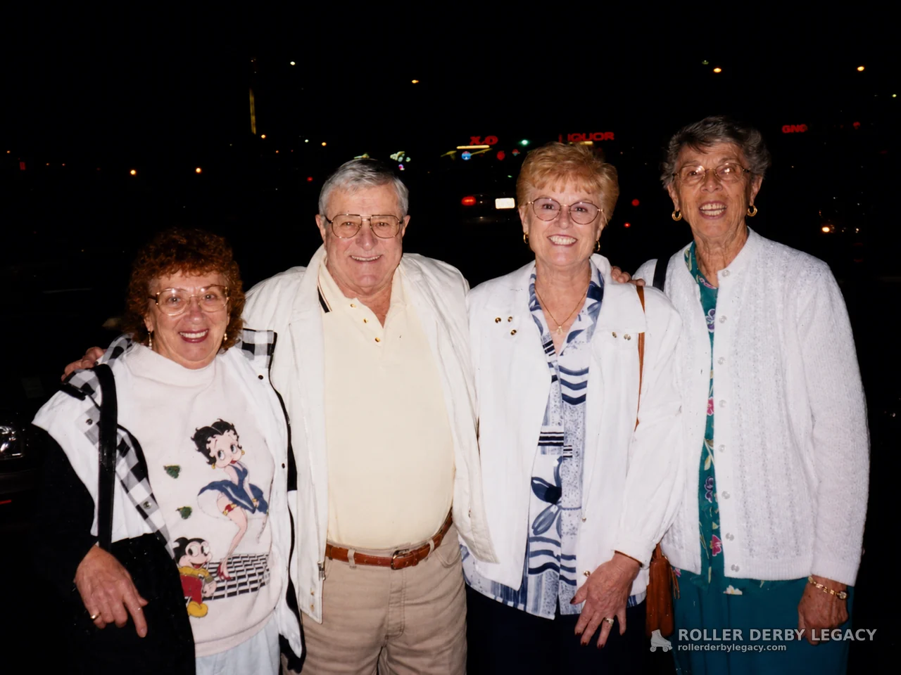 Four Adults Posing at Night in a Parking Area