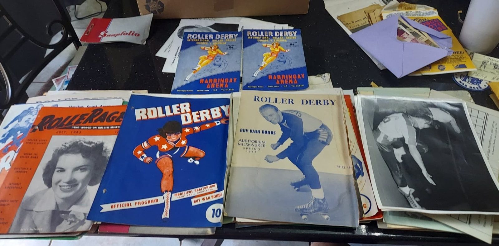 Vintage roller derby magazines and printed programs.