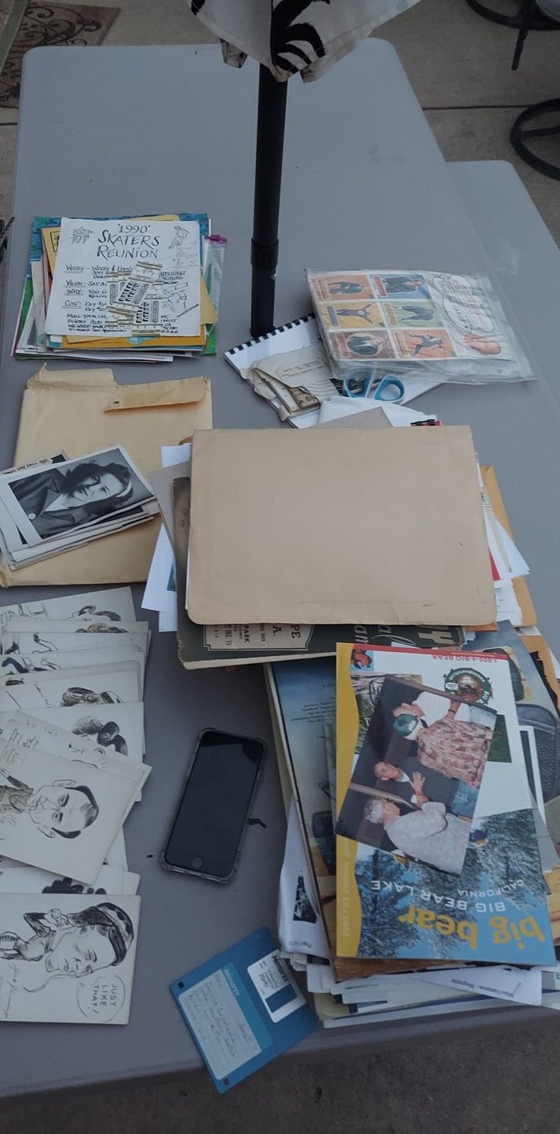 Photographs and ephemera laid out for review.