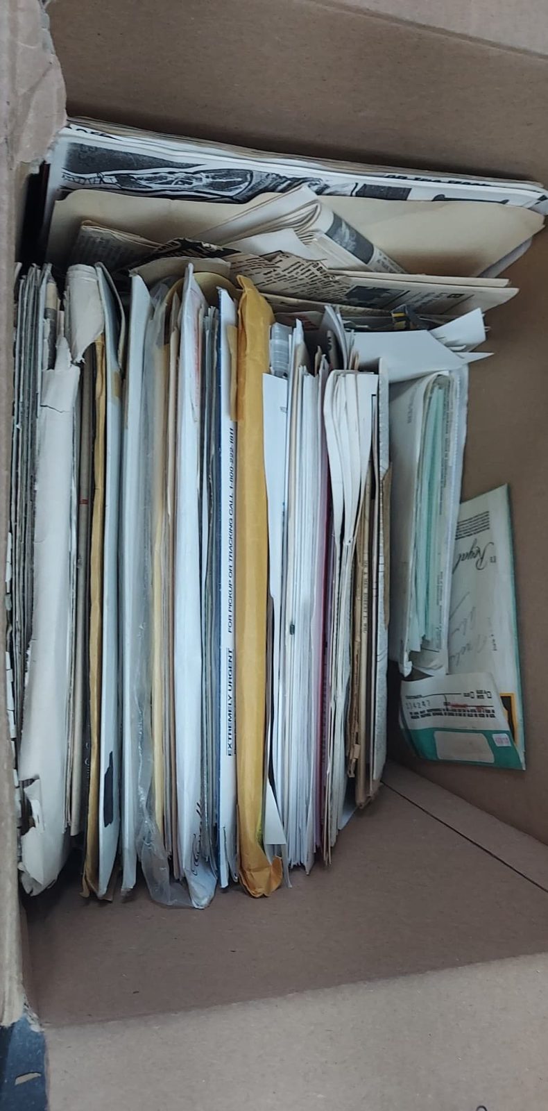 A storage box of vertically filed papers and records.