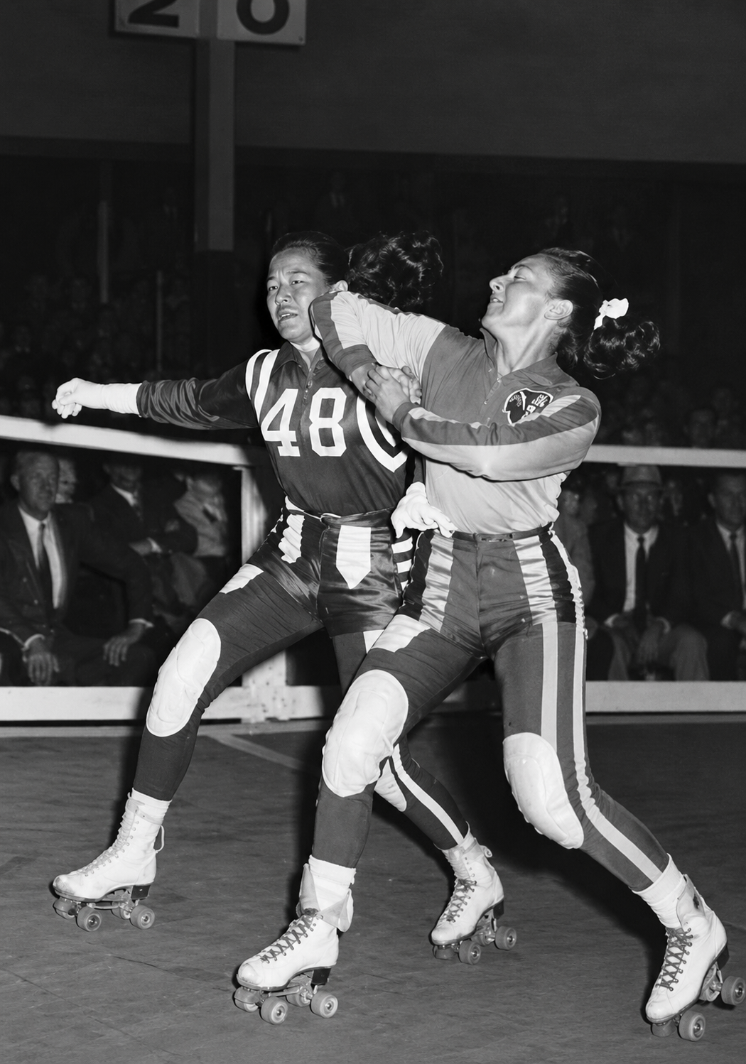 Loretta Behrens delivers a hard block against rival Gerry Murray on the banked track in Sydney, Australia, 1955.